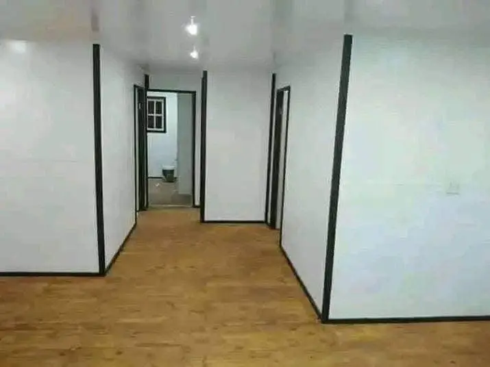 Neatly finished interior corridor with dark-framed partitions