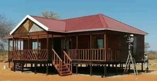 Raised timber house with a red roof and full front veranda